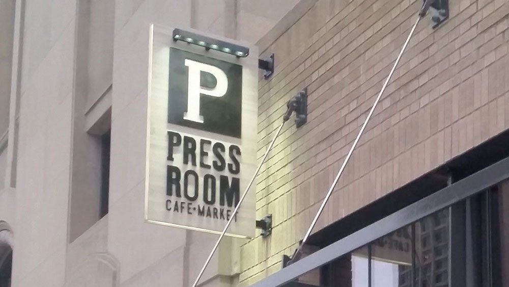 Press Room blade sign translucent illuminating retail signage