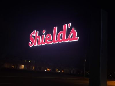 Shield's Front and Halo lit Illuminating Sign at night