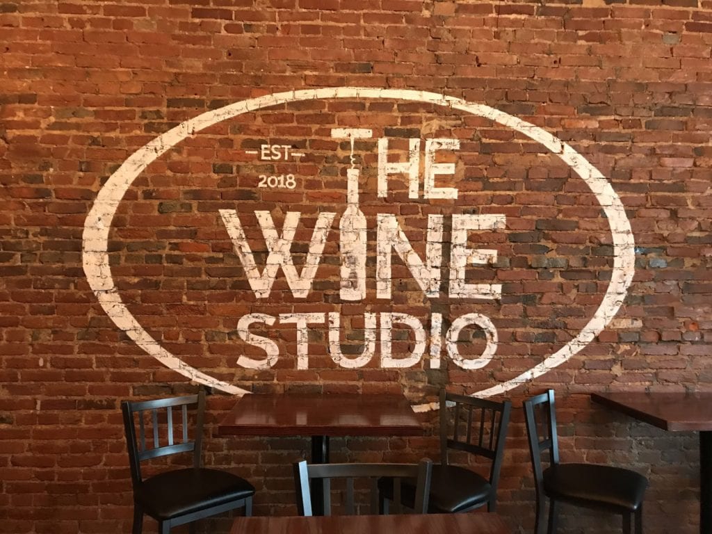 Wine Studio Wall Graphics white lettering on brick wall