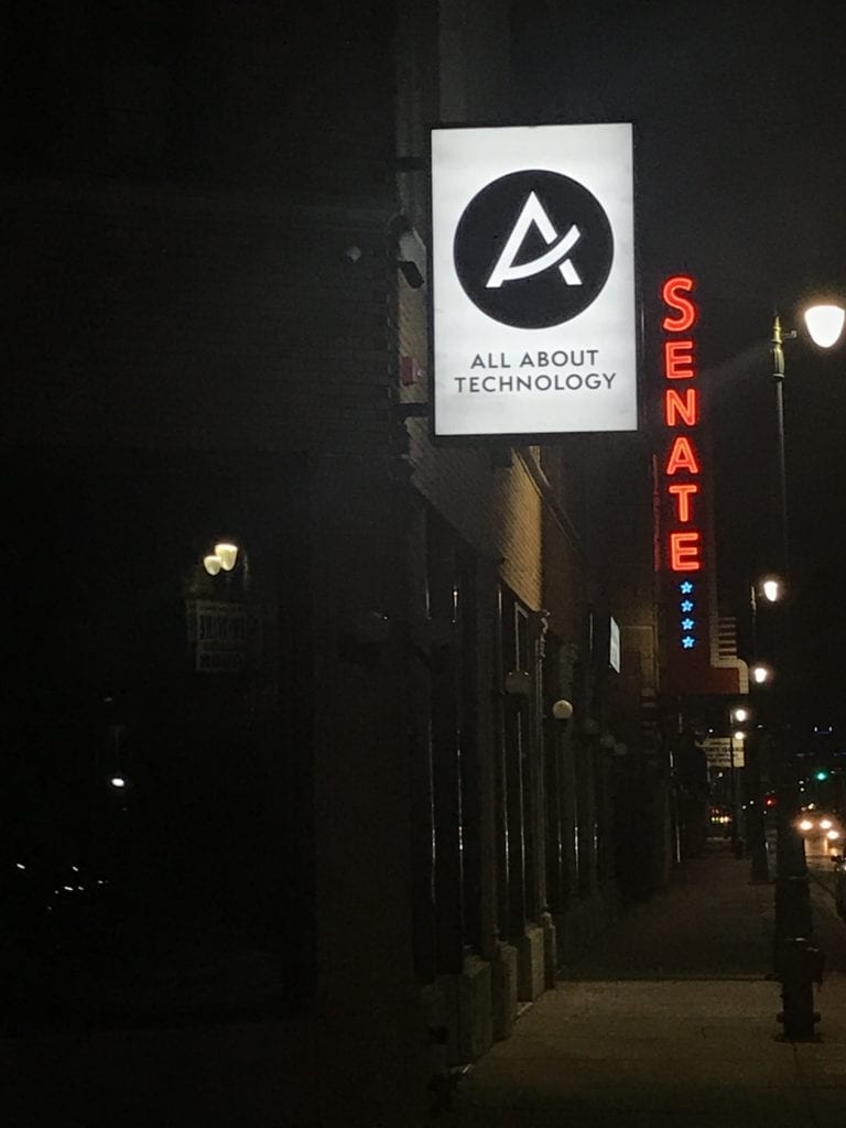 A illuminating blade sign LED lit retail signage night view