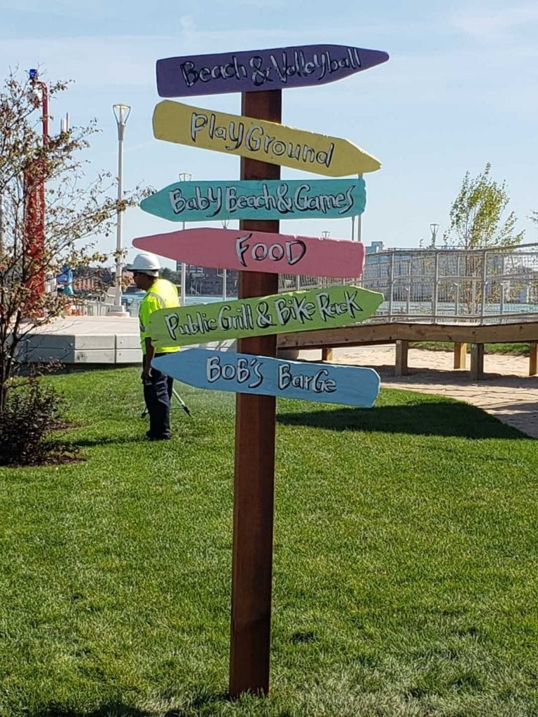 Atwater Directional Signs colorful arrows grass exterior