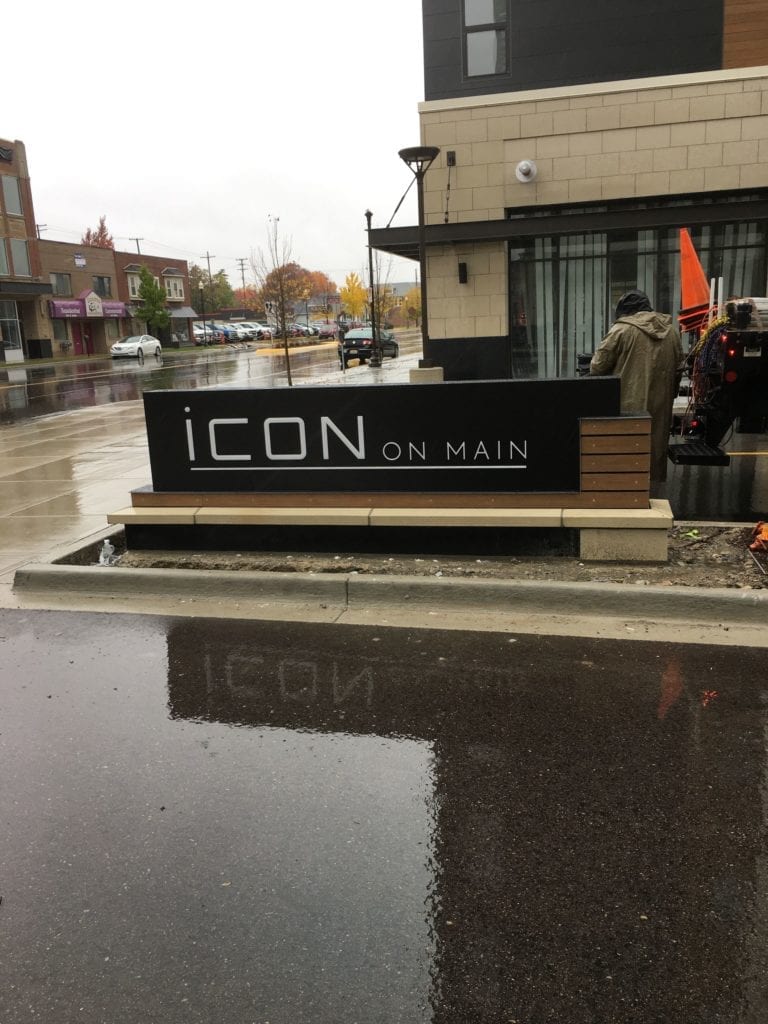 Icon Monument Sign - black with brick base and white lettering