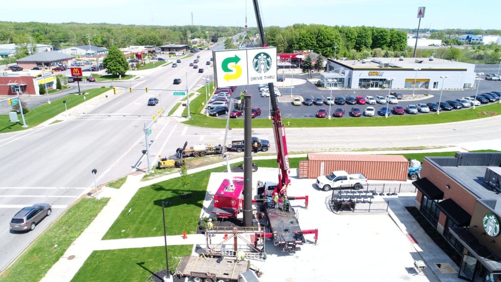 Large Starbucks/Subway Pylon Sign crane highway pylon