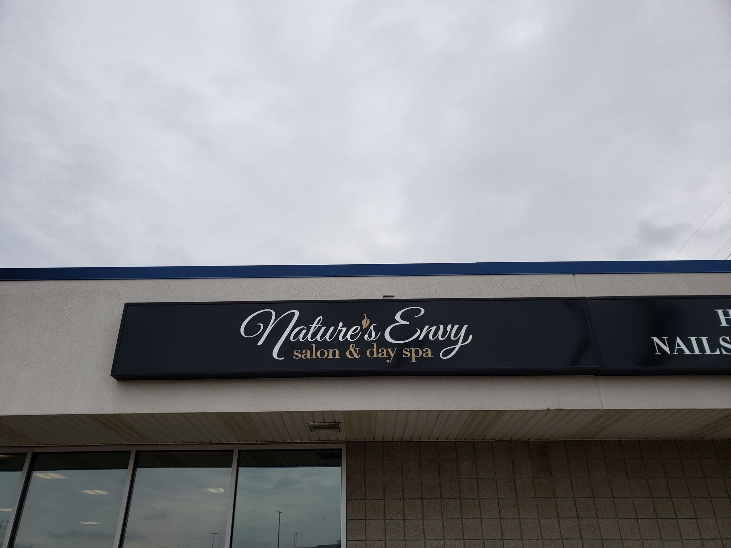 NATURE'S ENVY SALON AND DAY SPA - BLACK BOX SIGN WITH WHITE AND GOLD LETTERING